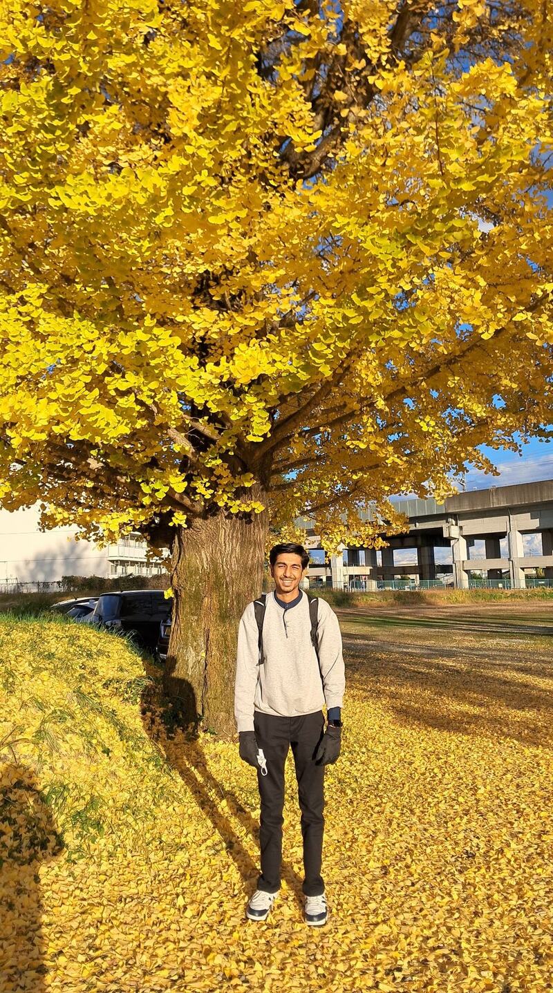 Tejas Pagare standing under a ginkgo tree in autumn, Utsunomiya